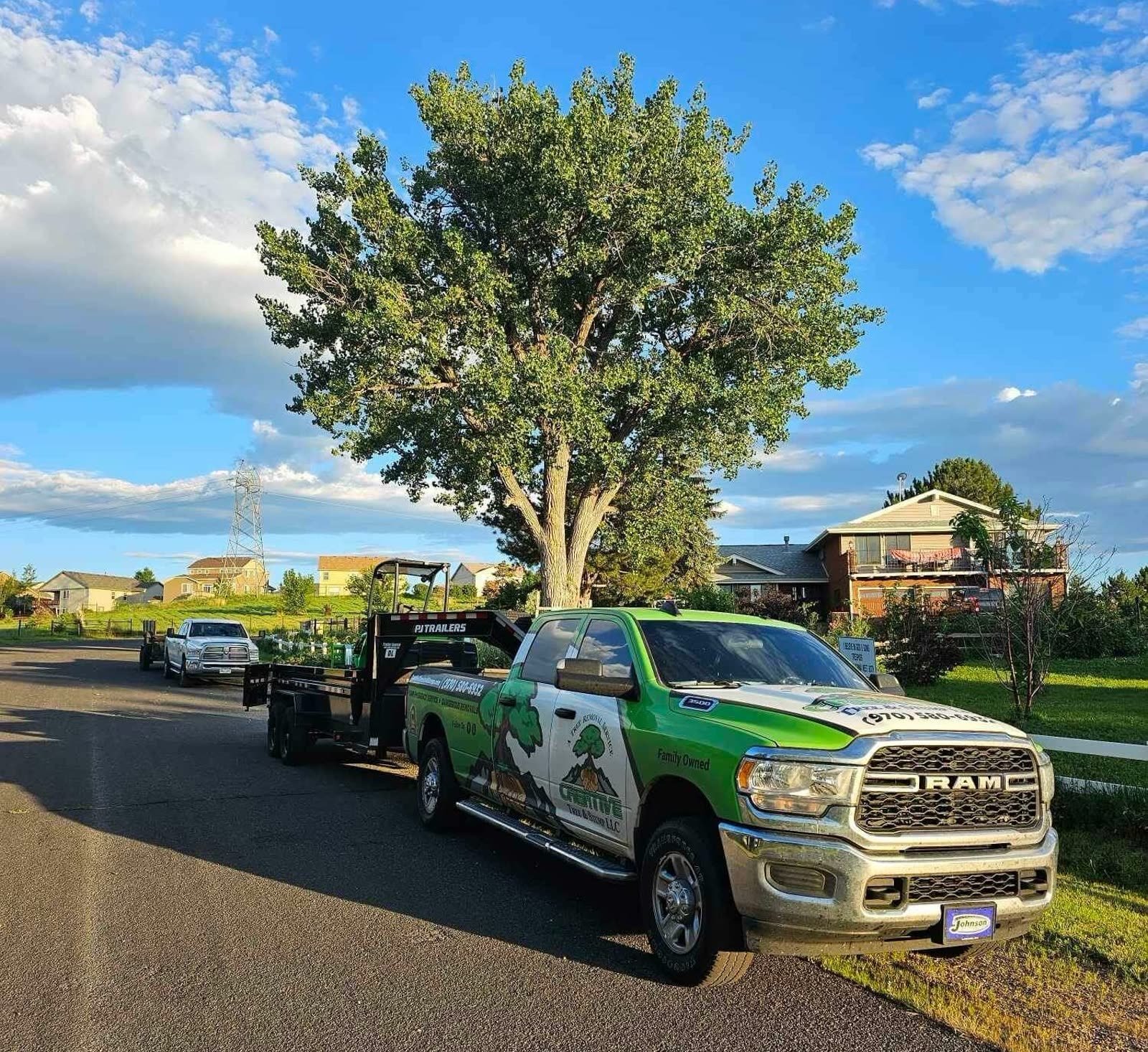 Tree work at a brick home with a lift on site