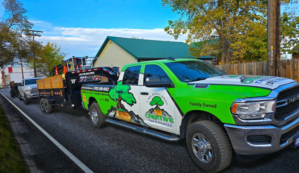 Creative Tree & Stump truck and trailer with lift loaded, on the street
